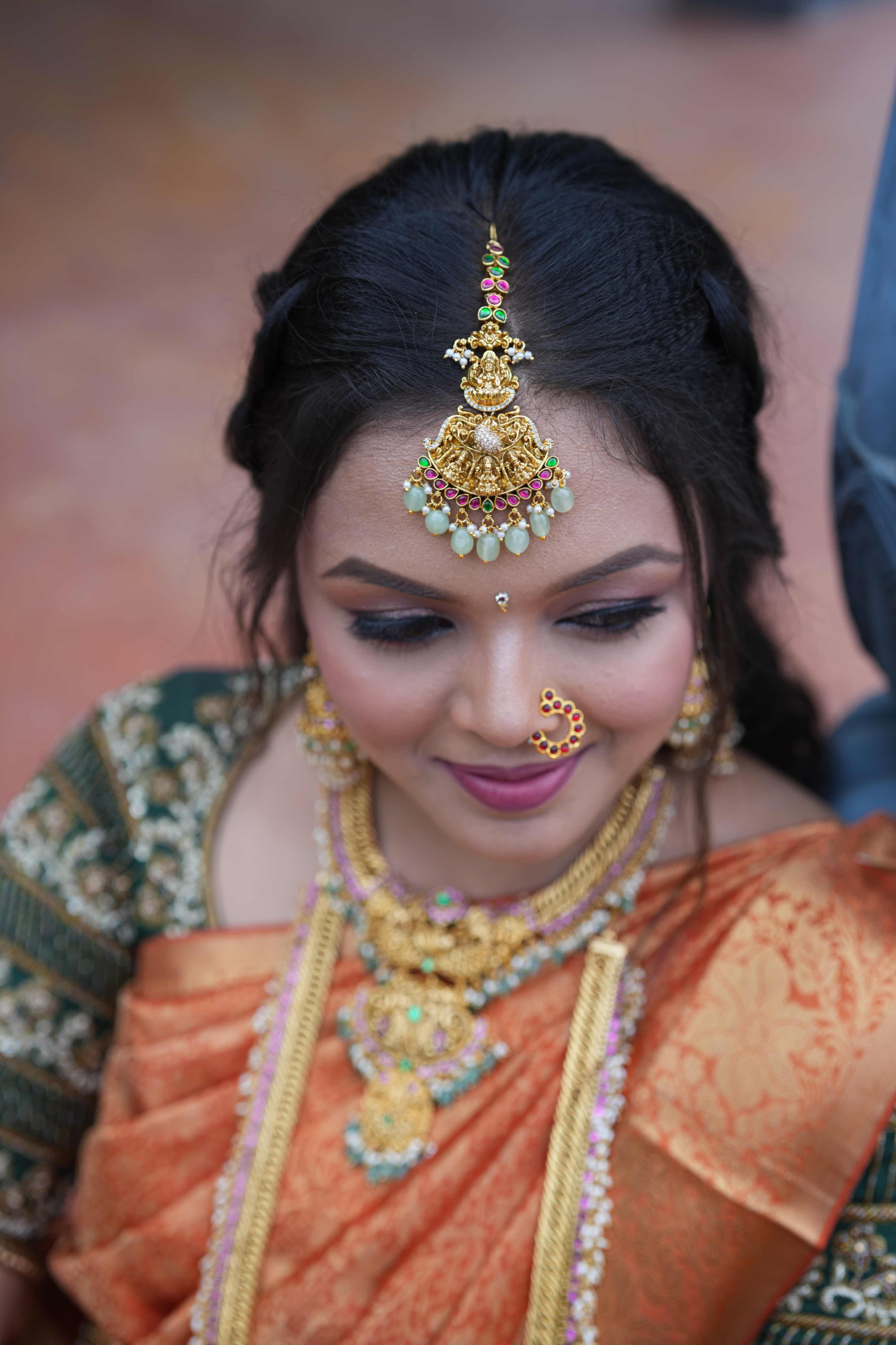 Antique Finish Earchain with Jhumka motifs studded with red and green