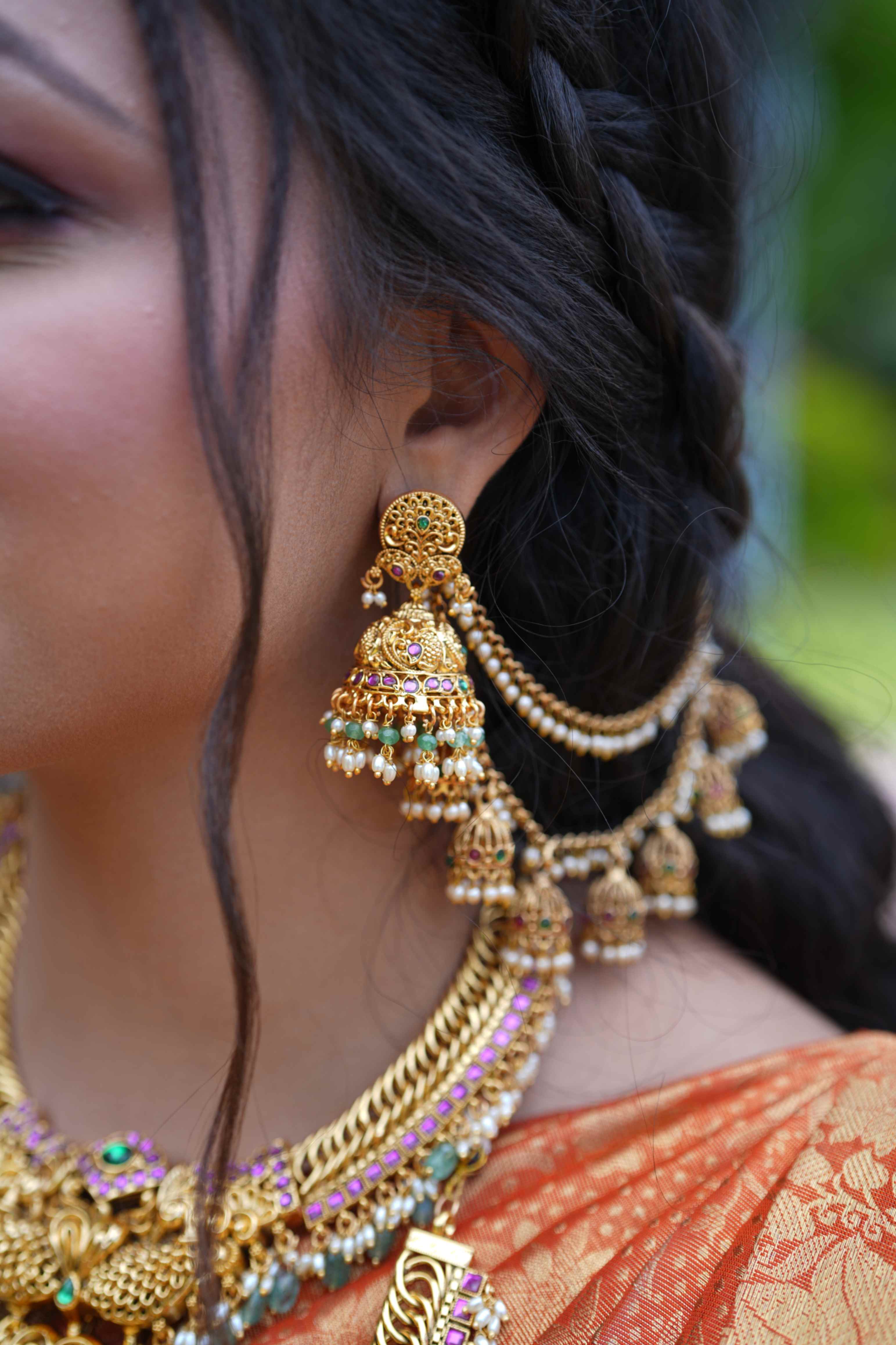 Antique Finish Earchain with Jhumka motifs studded with red and green
